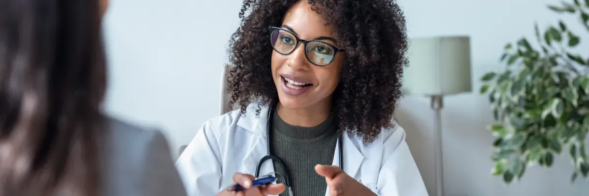 Woman doctor speaking about the health importance of getting proper sleep and choosing the right mattress for support.